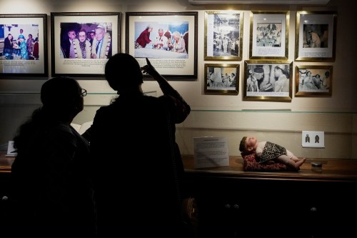 Visitors view photos displayed inside a museum showcasing Cochin's Jewish history next to the 458-year-old Paradesi Synagogue in the historic Jew Town neighborhood of Kochi, India, Wednesday, May 20, 2026. (AP Photo/Aijaz Rahi)