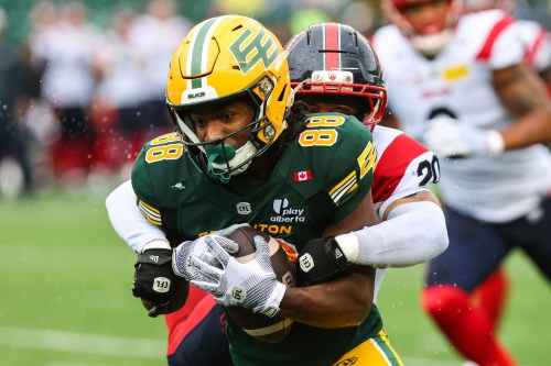 Edmonton Elks' TJ Luther (88) is tackled by Montreal Alouettes' Lorenzo Burns (20) during first half CFL football action in Edmonton on Saturday, June 20, 2026. THE CANADIAN PRESS/Codie McLachlan