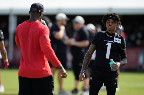 Houston Texans wide receiver Tank Dell (1) greets head coach DeMeco Ryans during the team's NFL football training camp in Houston, Friday, August 7, 2026. (AP Photo/Ashley Landis)