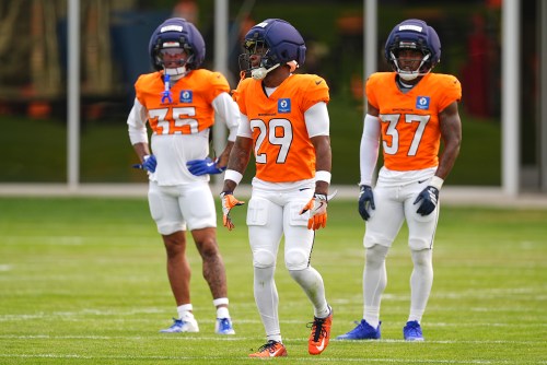 Denver Broncos cornerback Ja'quan McMillian, center, waits to take part in drills as cornerbacks Reese Taylor, left, and rookie defensive back Sean Fresch Jr., right, look on during a practice at the NFL team's training camp Monday, Aug. 3, 2026, in Centennial, Colo. (AP Photo/David Zalubowski)