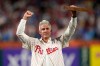 Former Philadelphia Phillies' Chase Utley reacts during a ceremony honoring him before a baseball game between the Philadelphia Phillies and the Toronto Blue Jays Friday, Aug. 7, 2026, in Philadelphia. (AP Photo/Matt Slocum)