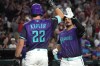 Arizona Diamondbacks' Nolan Arenado, right, celebrates with Max Kepler (22) after hitting a solo home run against the Los Angeles Dodgers in the second inning of a baseball game, Friday, Aug 7, 2026, in Phoenix. (AP Photo/Rick Scuteri)