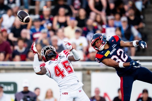 Calgary Stampeders' Benny III Sapp (45) and Montreal Alouettes' Shakespeare Louis (22) look for a catch during first half CFL football action in Montreal on Saturday, July 11, 2026. THE CANADIAN PRESS/Christopher Katsarov