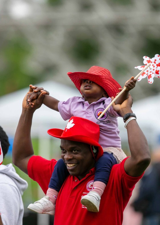 Ade Adeagbo and his two-year-old daughter Elizabeth Adeagbo celebrate Canada Day at The Forks. (Brook Jones / Free Press)