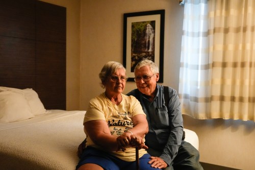 Ella Arney and Basil Arney sit in their hotel room in Thunder Bay, Ont., Friday, July 17, 2026, after being evacuated from their home in McKenzie Lake due to the threat of wildfires. THE CANADIAN PRESS/Chris Young