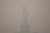 The Statue of Liberty stands during sunset as smoke from wildfires blankets the sky, Thursday, July 16, 2026, in the Brooklyn borough of New York. THE CANADIAN PRESS/AP-Yuki Iwamura