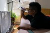 A person drinks water in front of a box fan while trying to stay cool in their apartment without air conditioning in Portland, Ore., on Thursday, Aug. 12, 2021. THE CANADIAN PRESS/AP-Nathan Howard