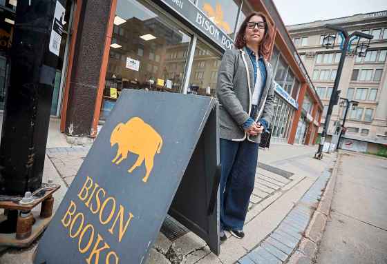 Aimee Peake, owner of Bison Books, says foot traffic has cratered since the city moved transit buses off Graham Avenue. (John Woods / Free Press files)