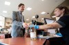 B.C. Premier David Eby purchases a bottle of wine from Summerland, B.C., after a news conference in Vancouver on Tuesday, Aug. 25, 2026. THE CANADIAN PRESS/Ethan Cairns