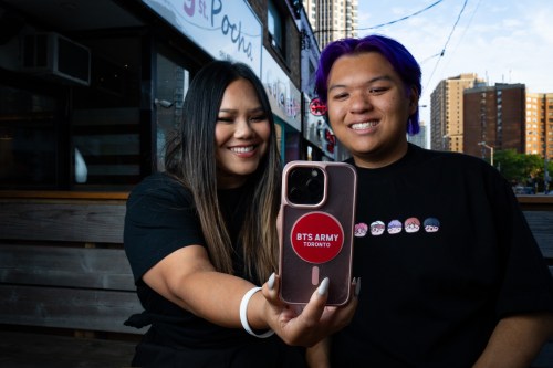 Sokvin Vann and her son Jordan, the duo behind BTS Army Toronto, record a video with a cellphone in Toronto on Tuesday, August 18, 2026. THE CANADIAN PRESS/Arlyn McAdorey