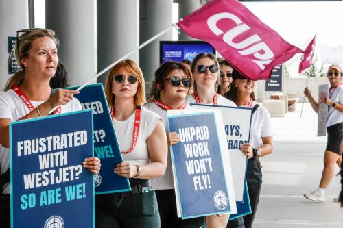JOHN WOODS / FREE PRESS
                                In Winnipeg, 240 WestJet flight attendants walked off the job and were marching outside of the airport terminal Sunday as part of a nationwide strike.