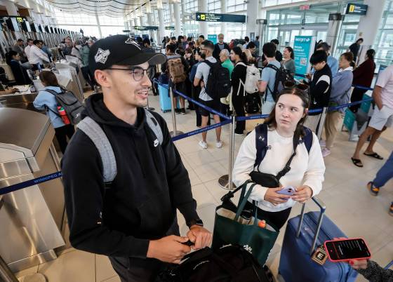 Westjet passengers Alistair Viegas and Allie Mills drove from Calgary to try to sort out their flight plans. (John Woods / Free Press)