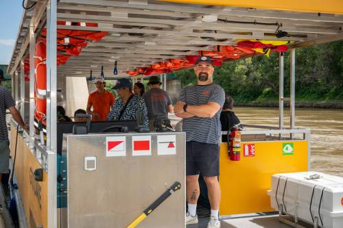 ROBERT LEE / FREE PRESS
                                Will Belford, co-owner of Winnipeg Waterways, poses with the new boat for the water-bus service stationed at The Forks on Wednesday.