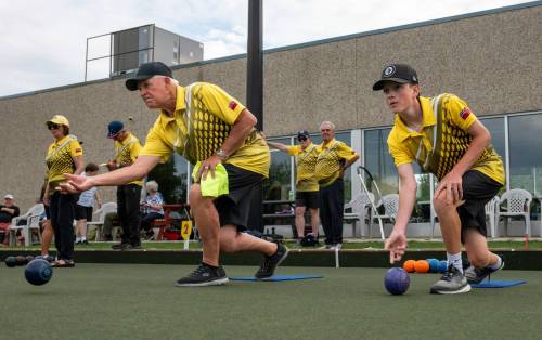 ROBERT LEE / FREE PRESS
                                Sam Forrest (right) bowls alongside his grandfather, John Bjornson, during a send-off game at the Dakota Lawn Bowling Centre.