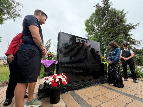 MORGAN MODJESKI/FREE PRESS
                                Chris Anderson and his wife Rachael, look on at MADD Canada's Manitoba Memorial which now carries his brother Robbie Anderson's name at the Glen Eden Funeral Home and Cemetery in West St. Paul on Saturday. Its placement is alongside the names of 85 other victims who died as a result of drunk or drug-related impaired driving. Joined by officials from the province and the law enforcement, he said he's grateful for the support and the work MADD does.