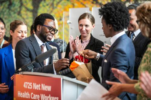 MIKAELA MACKENZIE / FREE PRESS
                                Dr. Ayomikun Soyombo, emergency medicine physician (left), accepts gifts from Health Minister Uzoma Asagwara during the provincial announcment at Seven Oaks Hospital Tuesday.