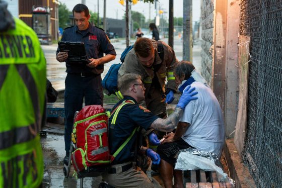 The rainy weather and scant details in a 911 call add to the challenges facing first responders who assist a man who had fallen in a walkway off of Main Street. (Robert Lee / Free Press)