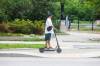 MIKE DEAL / FREE PRESS
                                An E-scooter rider makes their way along Assiniboine Avenue.