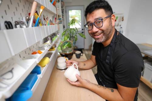 MIKE DEAL / FREE PRESS
                                Potter Eric Au in his home studio will be competing in a live pottery showdown at the WAG-Qaumajuq tonight.