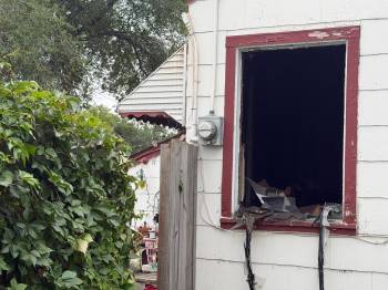 MORGAN MODJESKI / Free Press
                                A shattered window at the scene of a fatal house fire.