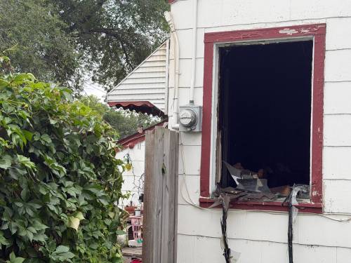 MORGAN MODJESKI / Free Press
                                A shattered window at the scene of a fatal house fire.