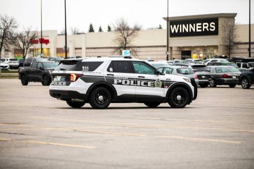 MIKAELA MACKENZIE / FREE PRESS FILES
                                A police car drives through retail parking lots in Unicity on Thursday, Nov. 6, 2025. For retail theft story. Free Press 2025