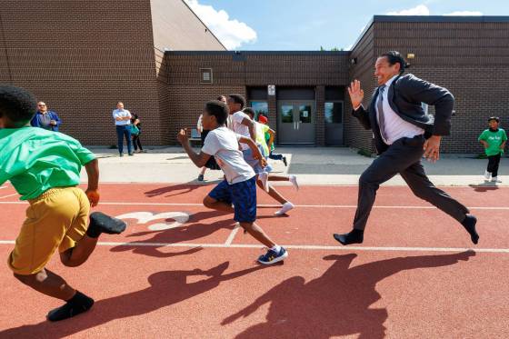 Premier Wab Kinew runs a race with kids from the Boys and Girls Club of Winnipeg last Thursday, after introducing a pilot program for a new health and phys-ed curriculum that makes in-person physical activity mandatory for all students from kindergarten to Grade 12. (Mike Deal / Free Press)