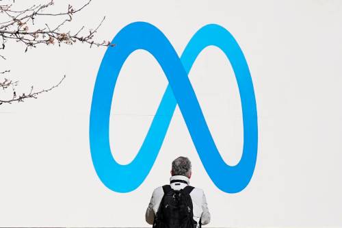ASSOCIATED PRESS FILES
                                A person stands in front of a Meta sign outside of the company&rsquo;s headquarters in Menlo Park, Calif.