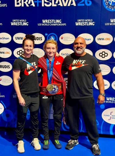 Supplied
                                From left: Wrestlers Madi Parks, Kaura Coles and Canadian national program coach David Spinney at the U20 worlds in Slovakia in August. Coles became just the fifth Canadian to win a U20 world title on Aug. 19, 2026.