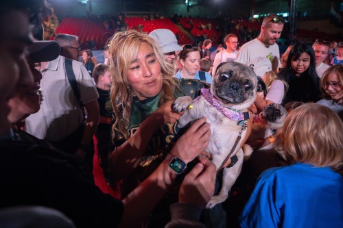 Lisa Sun carries one of her pugs during a meet and greet after a SuperDogs show at the PNE in Vancouver, on Thursday, Sept. 3, 2026. THE CANADIAN PRESS/Ethan Cairns