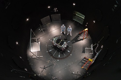 FILE - This photo provided by NASA shows Kieran Wilson, LINK's principal investigator, and Hunter Robertson, a space systems engineer, both at Katalyst Space, standing next to their spacecraft inside the SES (Space Environment Simulator) at NASA's Goddard Space Flight Center in Greenbelt, Md., April 17, 2026, ahead of thermal vacuum testing. (Sophia Roberts/NASA via AP, File)
