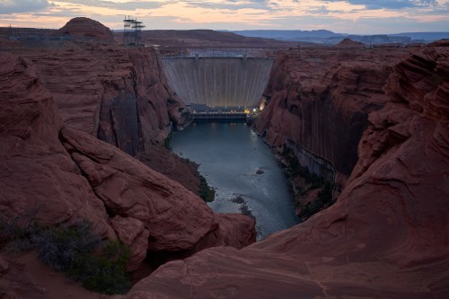The Colorado River flows beneath the Glen Canyon Dam at the Glen Canyon National Recreation Area, Tuesday, July 14, 2026, near Page, Nev. (AP Photo/John Locher)