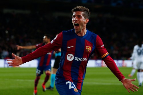 FILE - Barcelona's Sergi Roberto celebrates his sides third goal scored by Barcelona's Robert Lewandowski during the Champions League, round of 16, second leg soccer match between FC Barcelona and SSC Napoli at the Olympic Stadium in Barcelona, Spain, March 12, 2024. (AP Photo/Joan Monfort, File)