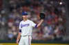 Texas Rangers starting pitcher Jacob deGrom reaches for a toss back during the third inning of a baseball game against the Baltimore Orioles, Saturday, Aug. 8, 2026, in Arlington, Texas. (AP Photo/LM Otero) CORRECTION: Corrects to deGrom not Degrom