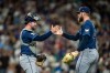 Tampa Bay Rays relief pitcher Bryan Baker, right, and catcher Liam Hicks celebrate after a baseball game against the Seattle Mariners, Saturday, Aug. 8, 2026, in Seattle. (AP Photo/Stephen Brashear)