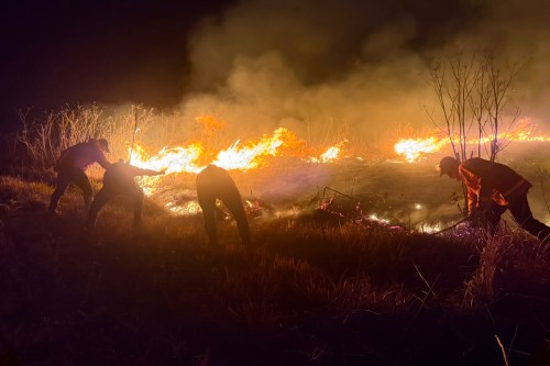 In this photo released by the East Java Regional Disaster Mitigation Agency, firefighters attempt to extinguish a wildfire that razes through Mount Bromo National Park in Probolinggo, Indonesia on Saturday, Aug. 8, 2026. (East Java Regional Disaster Mitigation Agency via AP)