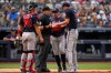 Atlanta Braves pitcher Chris Sale, right, argues with home plate umpire Dan Merzel, second left, during the fifth inning of a baseball game against the New York Yankees, Saturday, Aug. 8, 2026, in New York. (AP Photo/Yuki Iwamura)