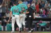 Miami Marlins' Kyle Stowers (28) is led off the field by manager Clayton McCullough (86) during the fifth inning of a baseball game against the Los Angeles Angels, Sunday, Aug. 9, 2026, in Miami. (AP Photo/Lynne Sladky)