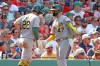 Athletics' Jeff McNeil (22) greetss teammate Tommy White (47) after scoring during the eighth inning of a baseball game against the Boston Red Sox, Sunday, Aug. 9, 2026, in Boston. (AP Photo/Mark Stockwell)