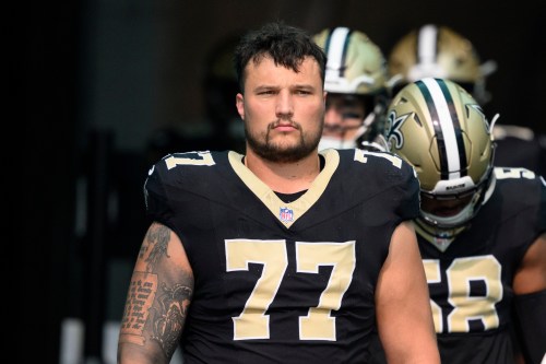 FILE - New Orleans Saints offensive lineman Dillon Radunz (77) prepares to walk onto the field before an NFL football game against the Miami Dolphins, on Nov. 30, 2025, in Miami Gardens, Fla. (AP Photo/Doug Murray, File)