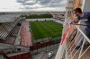 FILE - A man on a balcony watches the second-division game between Rayo Vallecano and Albacete in Madrid, Spain, on June 10, 2020. (AP Photo/Manu Fernandez, File)