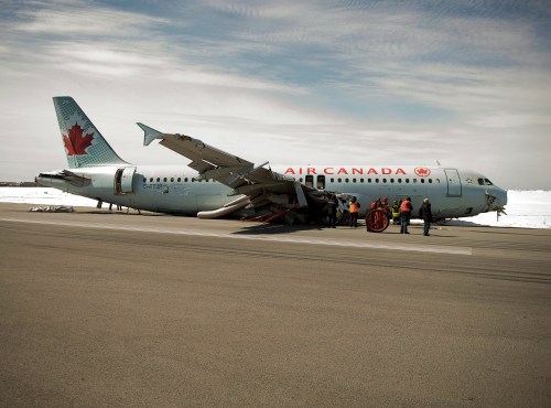 Transportation Safety Board investigators and airport firefighters work at the crash site of Air Canada AC624 at Stanfield International Airport in Halifax on Monday, March 30, 2015. THE CANADIAN PRESS/Andrew Vaughan