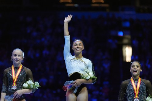All Around second place finisher Claire Pease, left, All Around Champion Hezly Rivera, center, and All Around third place finisher Charleigh Bullock, right, stand on the podium at the U.S. Gymnastics Championships, Sunday, Aug. 9, 2026, in Phoenix. (AP Photo/Ross D. Franklin)