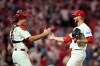 Philadelphia Phillies' J.T. Realmuto, left, and Caleb Kilian celebrate after the Phillies won a baseball game against the Washington Nationals Tuesday, Aug. 4, 2026, in Philadelphia. (AP Photo/Matt Slocum)