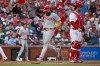 Philadelphia Phillies' Brandon Marsh, center, crosses home plate to score behind St. Louis Cardinals catcher Jimmy Crooks, right, in the second inning of a baseball game, Monday, Aug. 10, 2026, in St. Louis. (AP Photo/Joe Puetz)