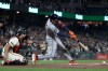 Houston Astros' Cam Smith, right, hits an RBI single in front of San Francisco Giants catcher Drew Cavanaugh, left, during the ninth inning of a baseball game in San Francisco, Monday, Aug. 10, 2026. (AP Photo/Jed Jacobsohn)