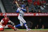 Texas Rangers' Brandon Nimmo, right, hits an RBI single during the 10th inning of a baseball game against the Los Angeles Angels, Monday, Aug. 10, 2026, in Anaheim, Calif. (AP Photo/William Liang)