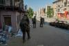 In this photo provided by Ukraine's 93rd Kholodnyi Yar Separate Mechanized Brigade press service and taken Monday, Aug. 10, 2026, Ukrainian soldiers walk along the street in the frontline town of Druzhkivka, Donetsk region, Ukraine. (Iryna Rybakova/Ukraine's 93rd Mechanized Brigade via AP))
