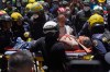 Rescue workers carry Diana Troncoso after pulling her from the rubble the day after an earthquake struck Pereira, Colombia, Tuesday, Aug. 11, 2026. (AP Photo/Ivan Valencia)