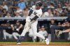 New York Yankees' Ryan McMahon hits a two-run RBI single during the seventh inning of a baseball game against the Seattle Mariners Tuesday, Aug. 11, 2026, in New York. (AP Photo/Frank Franklin II)